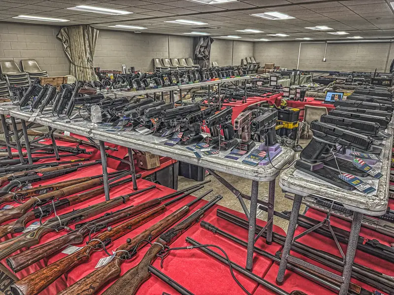Rifles and handguns laid out at an Indiana gun show