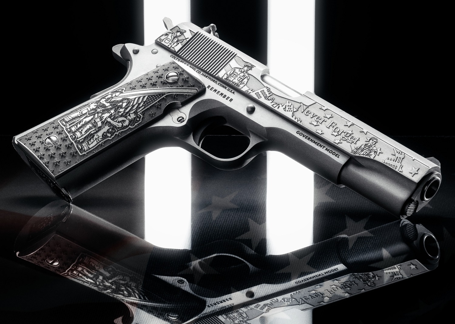 Engraved 1911 pistol angled on glossy dark surface, showing Never Forget slide and Remember grips